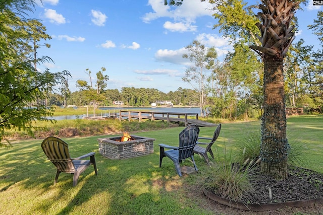 view of yard featuring a fire pit and a water view