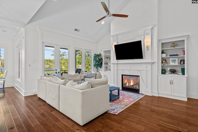 living room featuring high vaulted ceiling, ceiling fan, dark wood-type flooring, and a high end fireplace