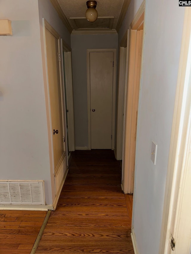 corridor featuring crown molding and dark hardwood / wood-style floors