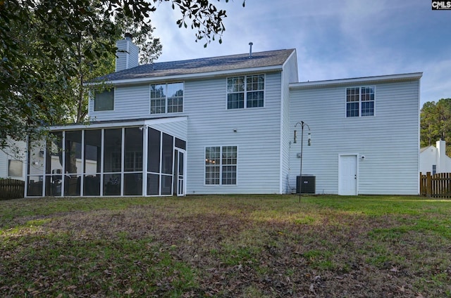 rear view of house featuring a yard, cooling unit, and a sunroom