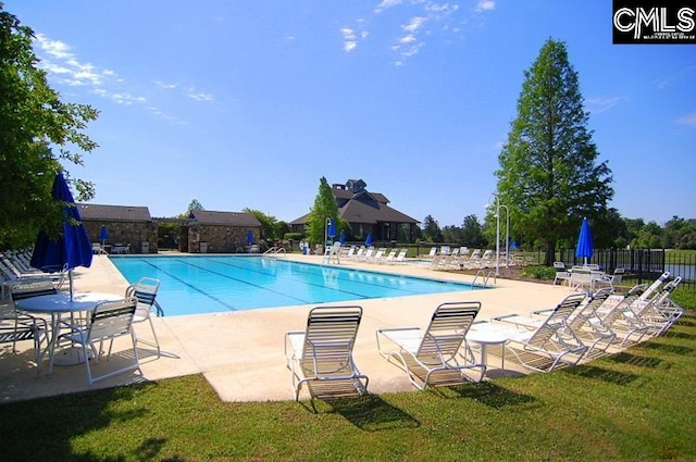 view of swimming pool with a lawn and a patio