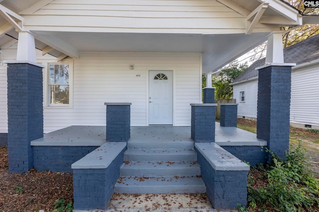 view of exterior entry with covered porch