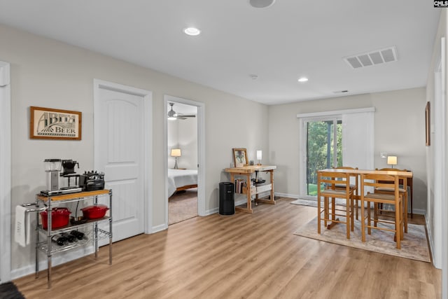 dining space with ceiling fan and light hardwood / wood-style floors