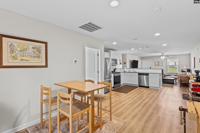 dining space featuring light hardwood / wood-style floors and ceiling fan