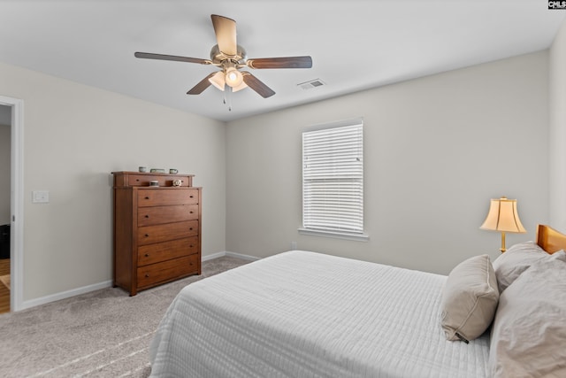 bedroom with ceiling fan and light carpet