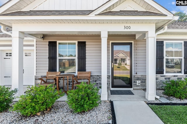 view of exterior entry featuring a porch