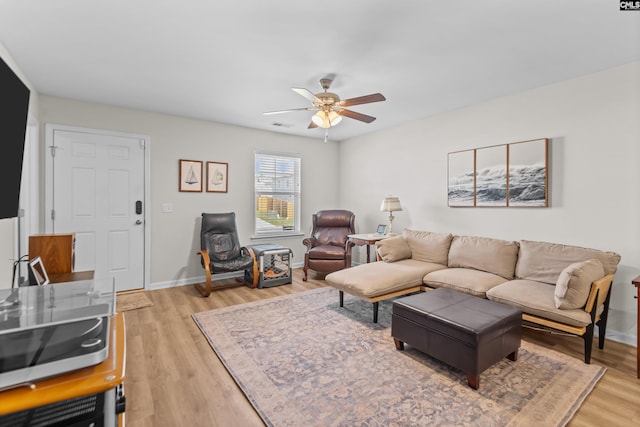 living room featuring ceiling fan and light wood-type flooring