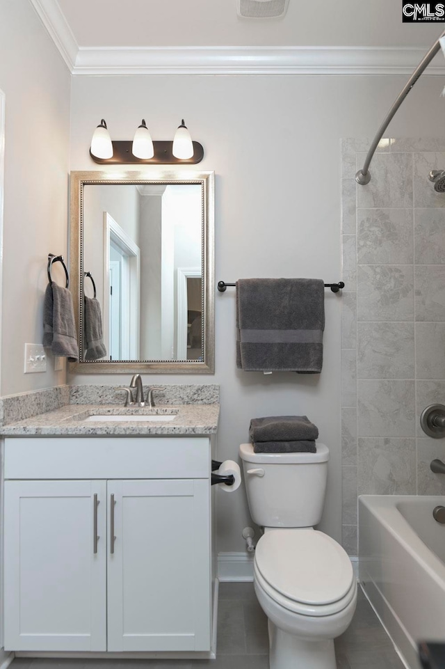 full bathroom with vanity, tile patterned floors, tiled shower / bath combo, toilet, and ornamental molding