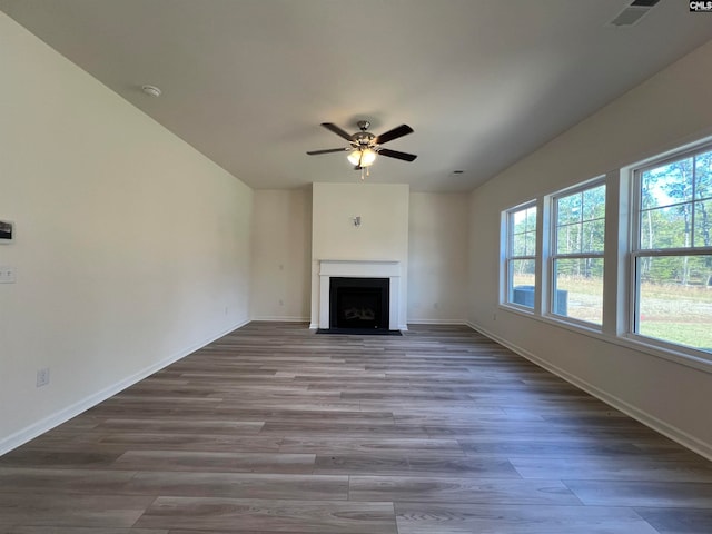 unfurnished living room featuring ceiling fan and wood-type flooring