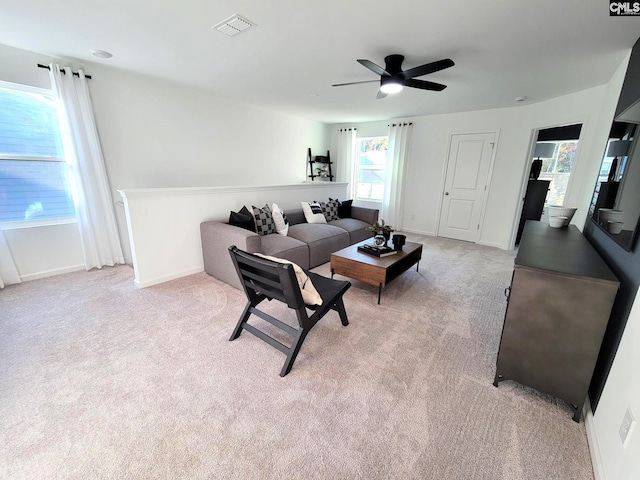 living room with ceiling fan and light colored carpet