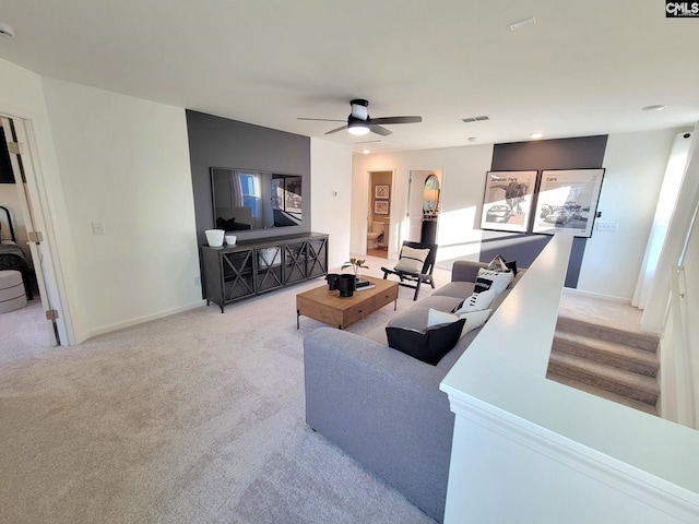 carpeted living room featuring ceiling fan