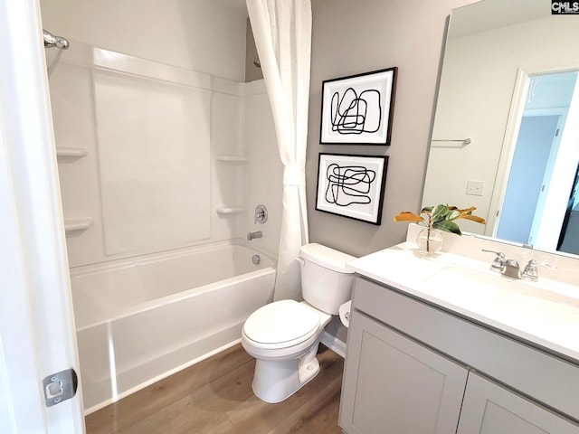 full bathroom with hardwood / wood-style floors, vanity, shower / bath combination, and toilet