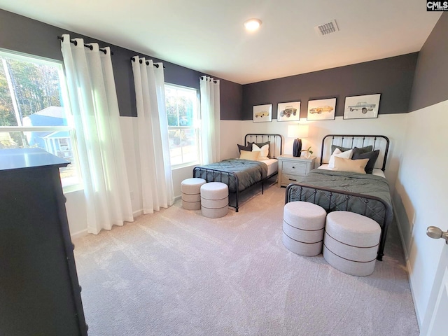 carpeted bedroom featuring multiple windows