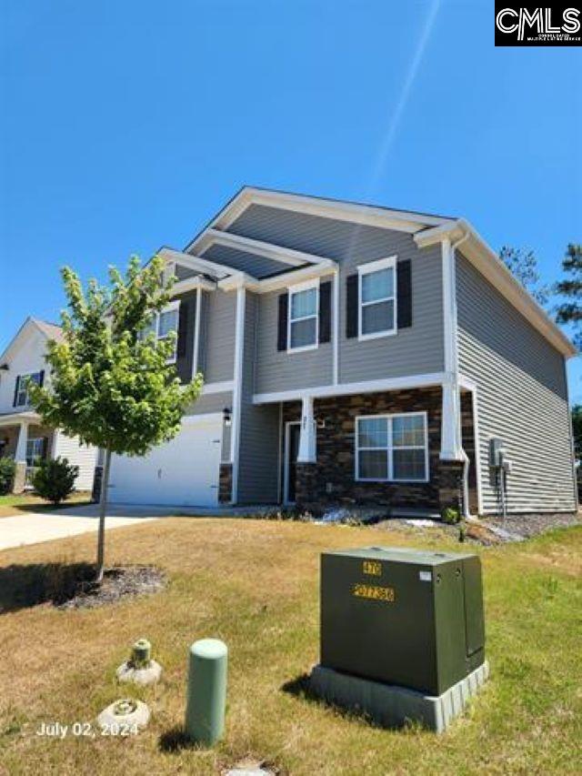 view of front of house featuring a garage and a front yard