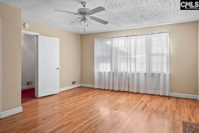 empty room featuring ceiling fan and light hardwood / wood-style flooring