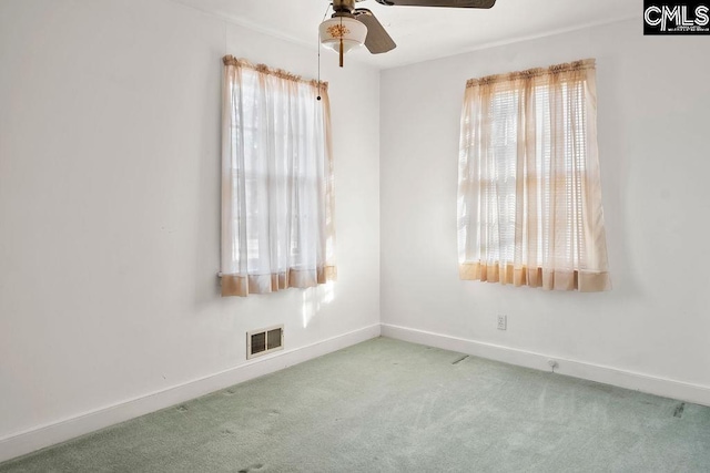 unfurnished room featuring ceiling fan and light carpet