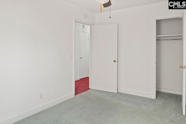 unfurnished bedroom with light carpet, ceiling fan, and a closet