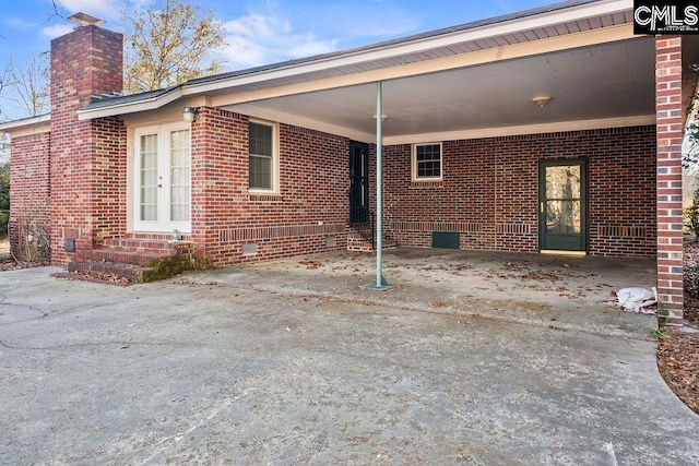 back of house with a carport