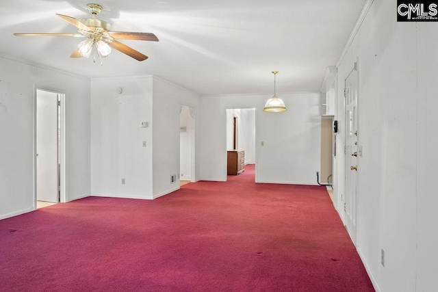 carpeted spare room featuring ceiling fan and crown molding