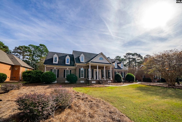 view of front of house featuring a porch and a front lawn