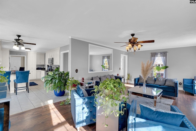 tiled living room featuring ceiling fan