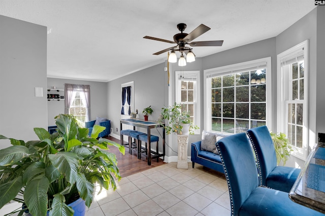 living room featuring ceiling fan and light tile patterned floors