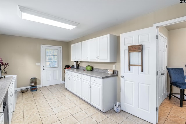 kitchen featuring white cabinets and light tile patterned flooring