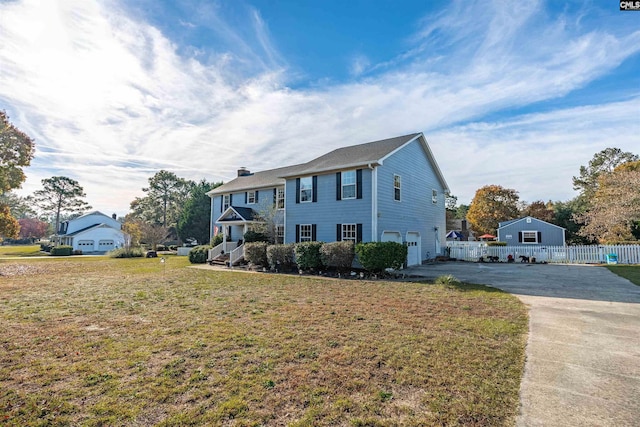 view of front of house with a front yard and a garage