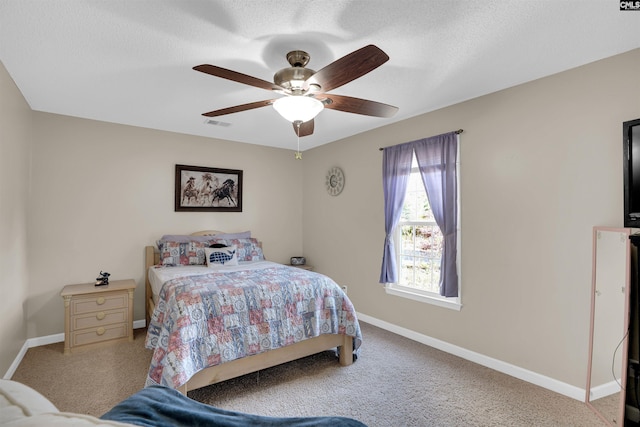 bedroom with a textured ceiling and ceiling fan