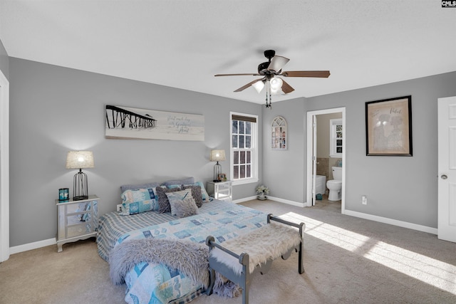 bedroom featuring connected bathroom, ceiling fan, and light colored carpet