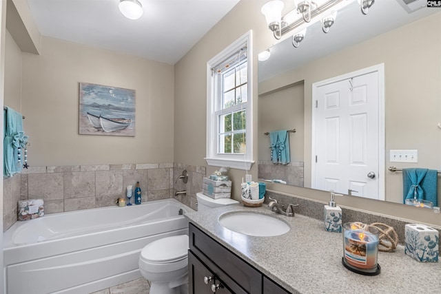 bathroom featuring tile patterned floors, vanity, toilet, and a tub to relax in