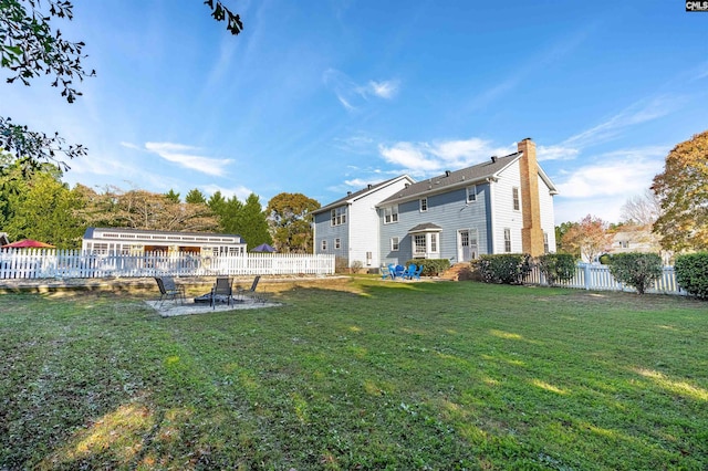 rear view of property with a lawn