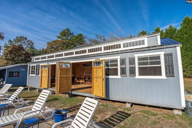 back of property with an outbuilding