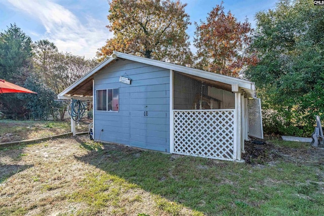 view of outbuilding featuring a lawn