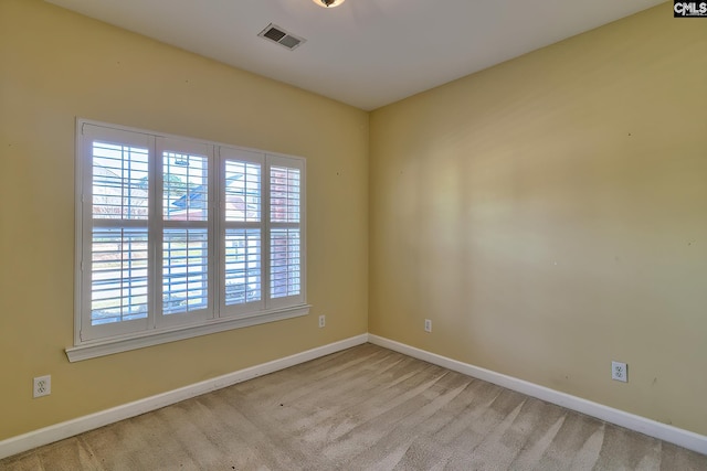 unfurnished room with light carpet