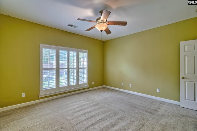 spare room with ceiling fan and light colored carpet