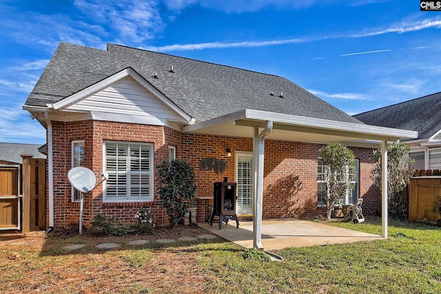 back of property featuring a patio area and a lawn