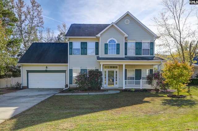 colonial house featuring covered porch, a garage, and a front yard