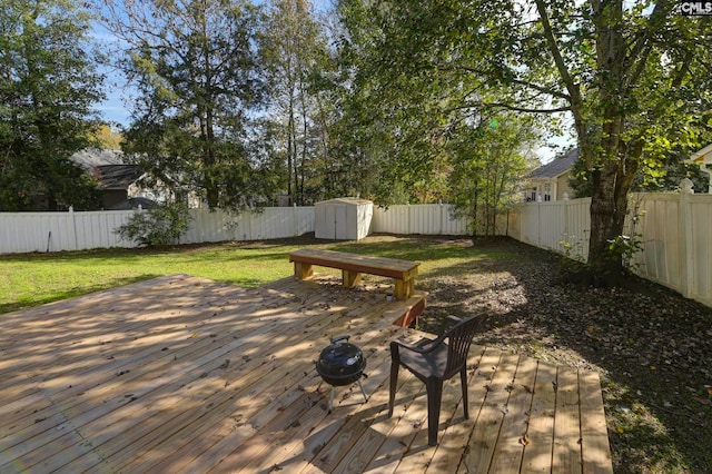 wooden deck with a lawn and a shed