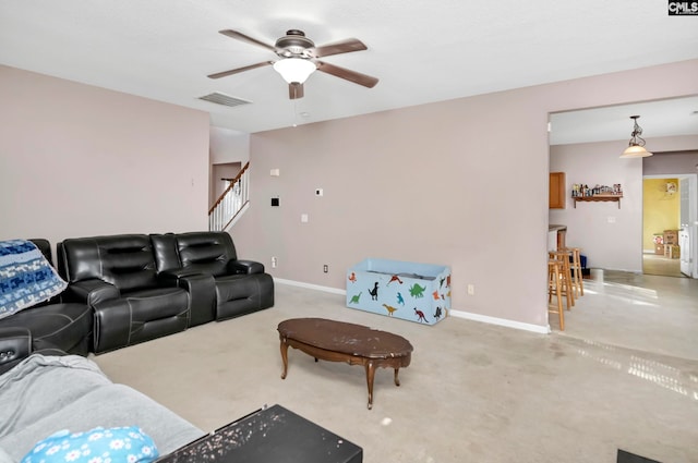 carpeted living room with ceiling fan