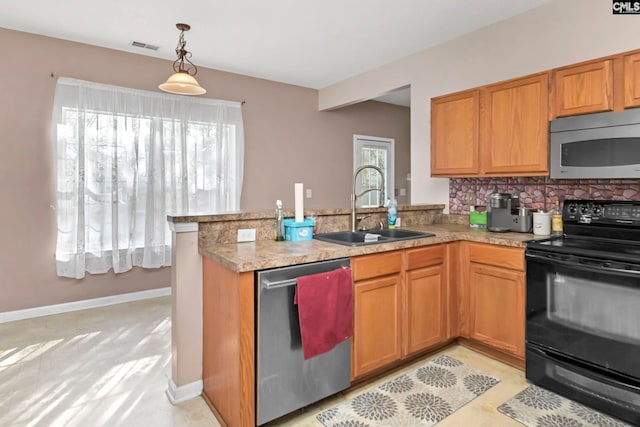 kitchen with pendant lighting, sink, tasteful backsplash, kitchen peninsula, and stainless steel appliances