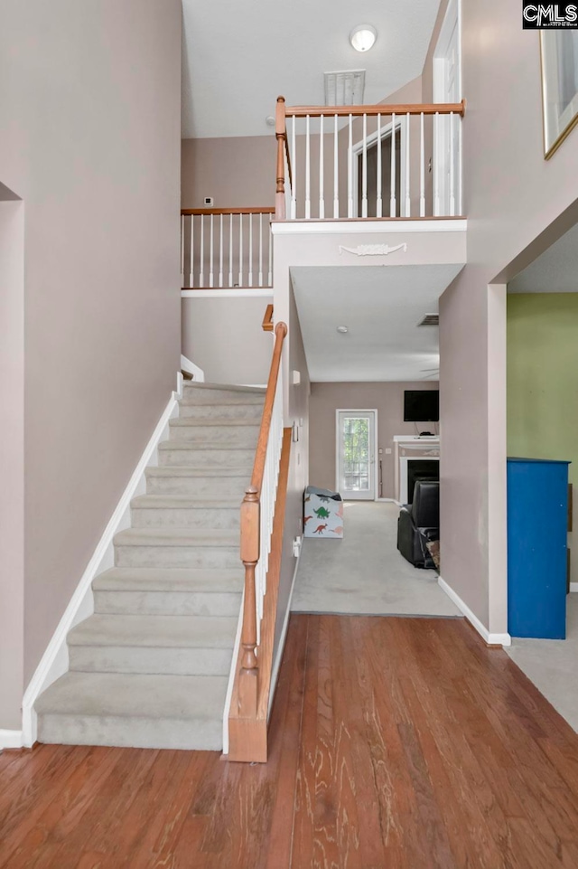 stairway featuring wood-type flooring