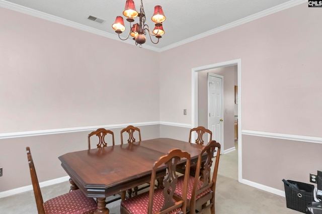 carpeted dining area featuring crown molding and a chandelier