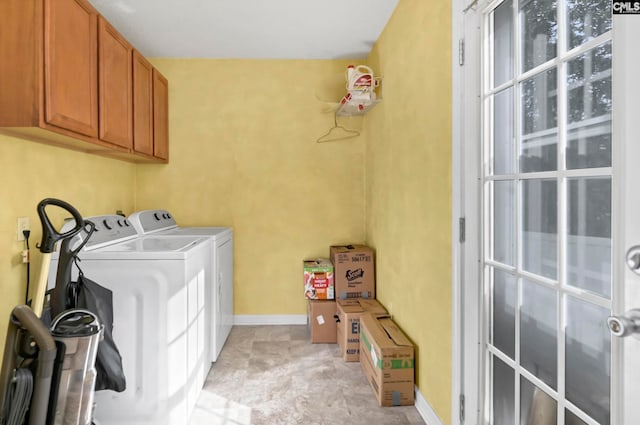 washroom featuring cabinets and washer and dryer