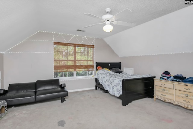 bedroom with carpet flooring, ceiling fan, lofted ceiling, and a textured ceiling