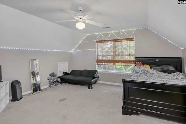 carpeted bedroom featuring ceiling fan and vaulted ceiling