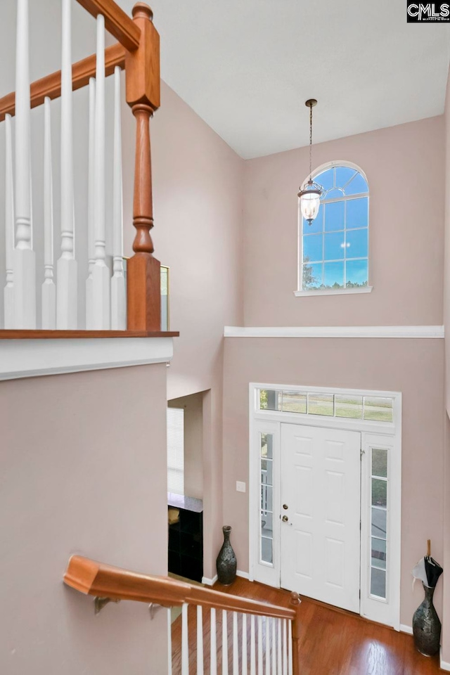 foyer featuring hardwood / wood-style floors and a notable chandelier