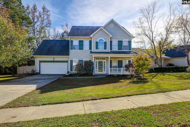 colonial home featuring covered porch, a garage, and a front yard