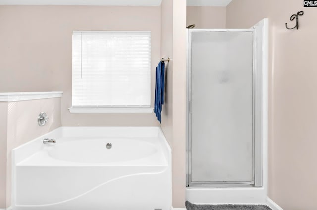 bathroom featuring independent shower and bath