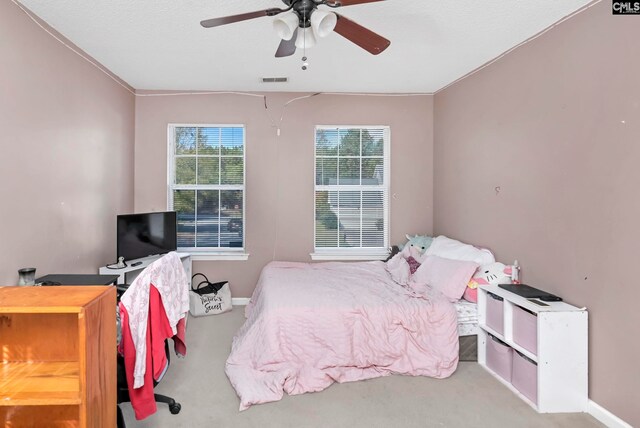 bedroom with ceiling fan, light colored carpet, and crown molding